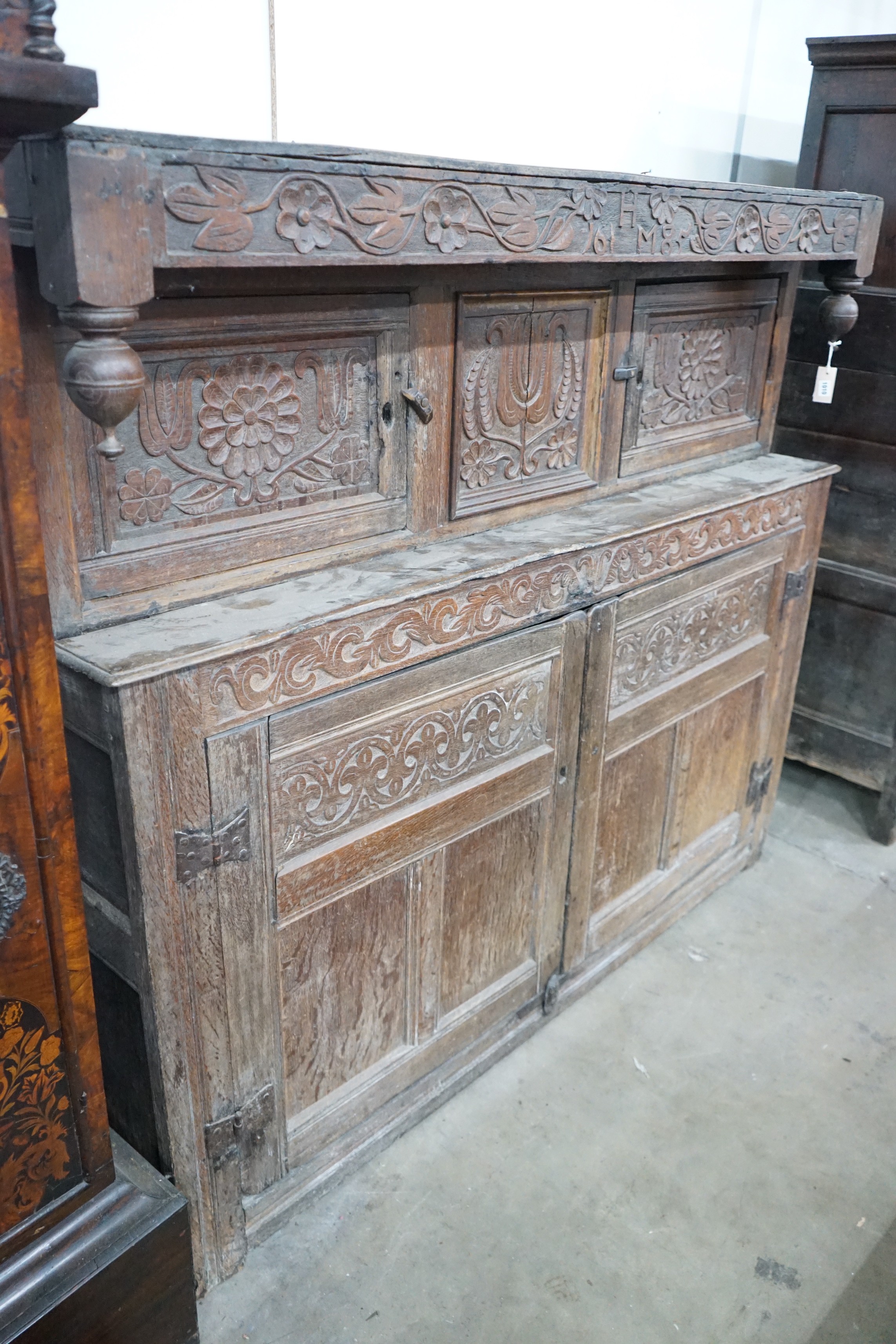 A 17th century carved oak court cupboard, dated 1685, width 170cm, depth 55cm, height 150cm